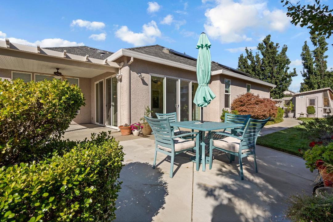 3685 Wimbledon Drive Redding, CA 96002 - Photo 58 of 70 a view of a patio with table and chairs and potted plants