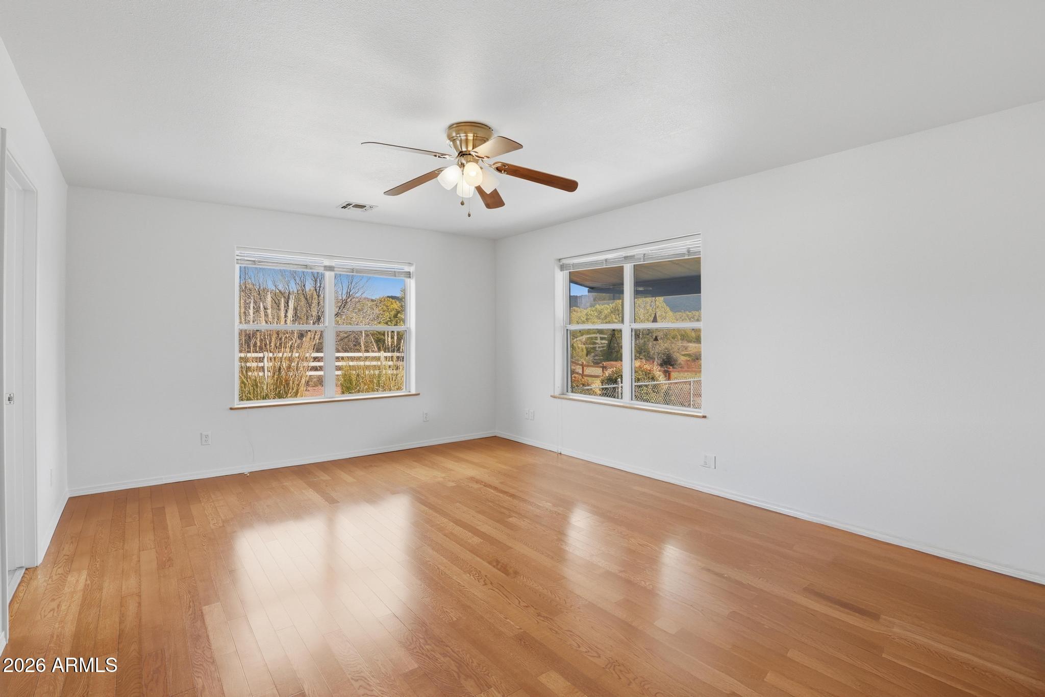 8780 Singletree Lane Payson, AZ 85541 - Photo 16 of 37 a view of an empty room with wooden floor and a window