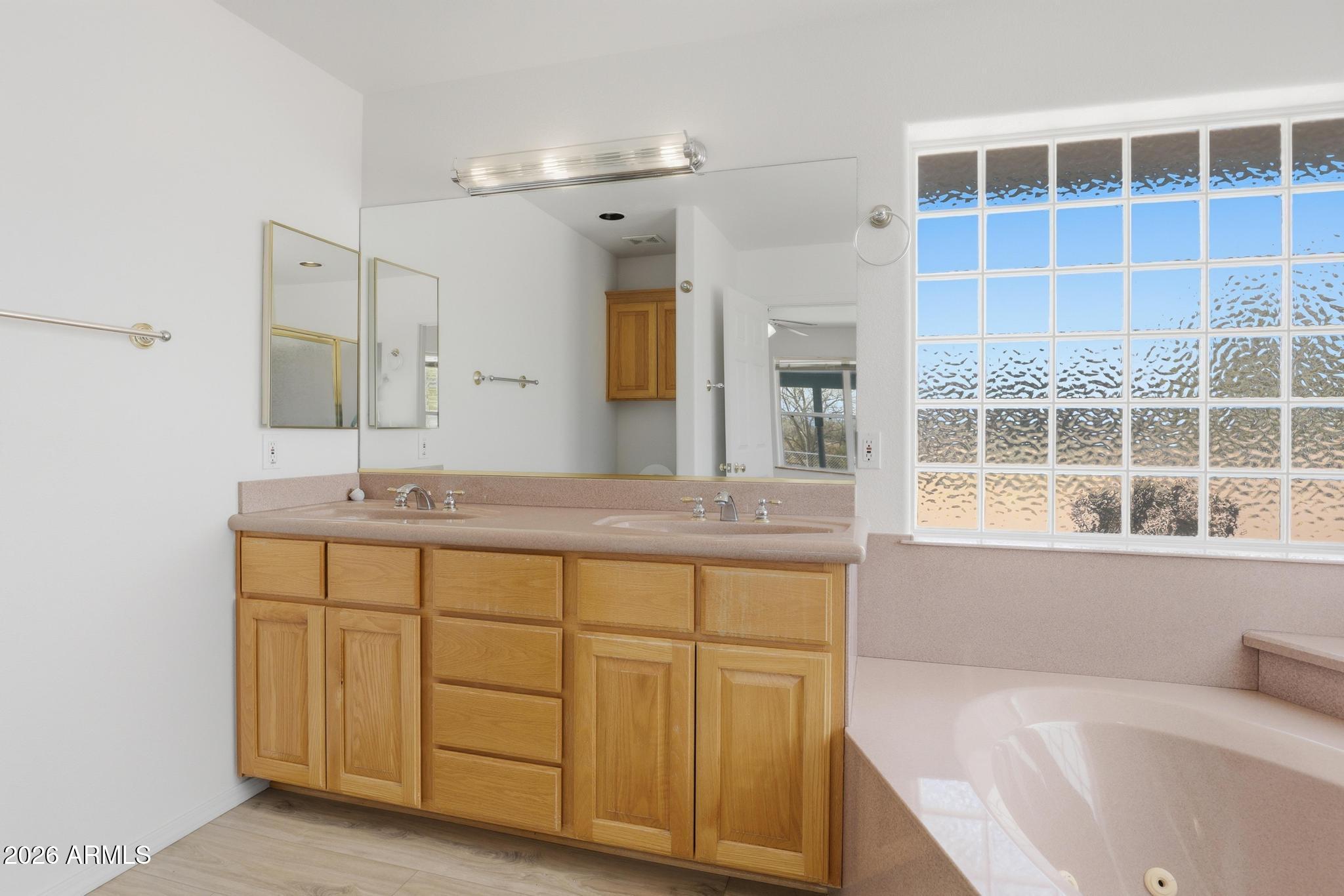 8780 Singletree Lane Payson, AZ 85541 - Photo 17 of 37 a bathroom with a tub sink and mirror