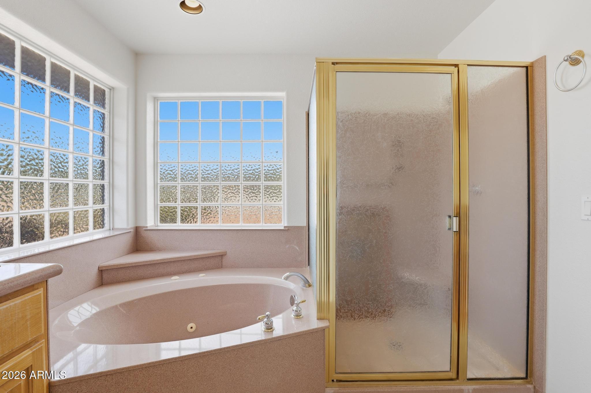 8780 Singletree Lane Payson, AZ 85541 - Photo 18 of 37 a bathroom with a bathtub and a shower