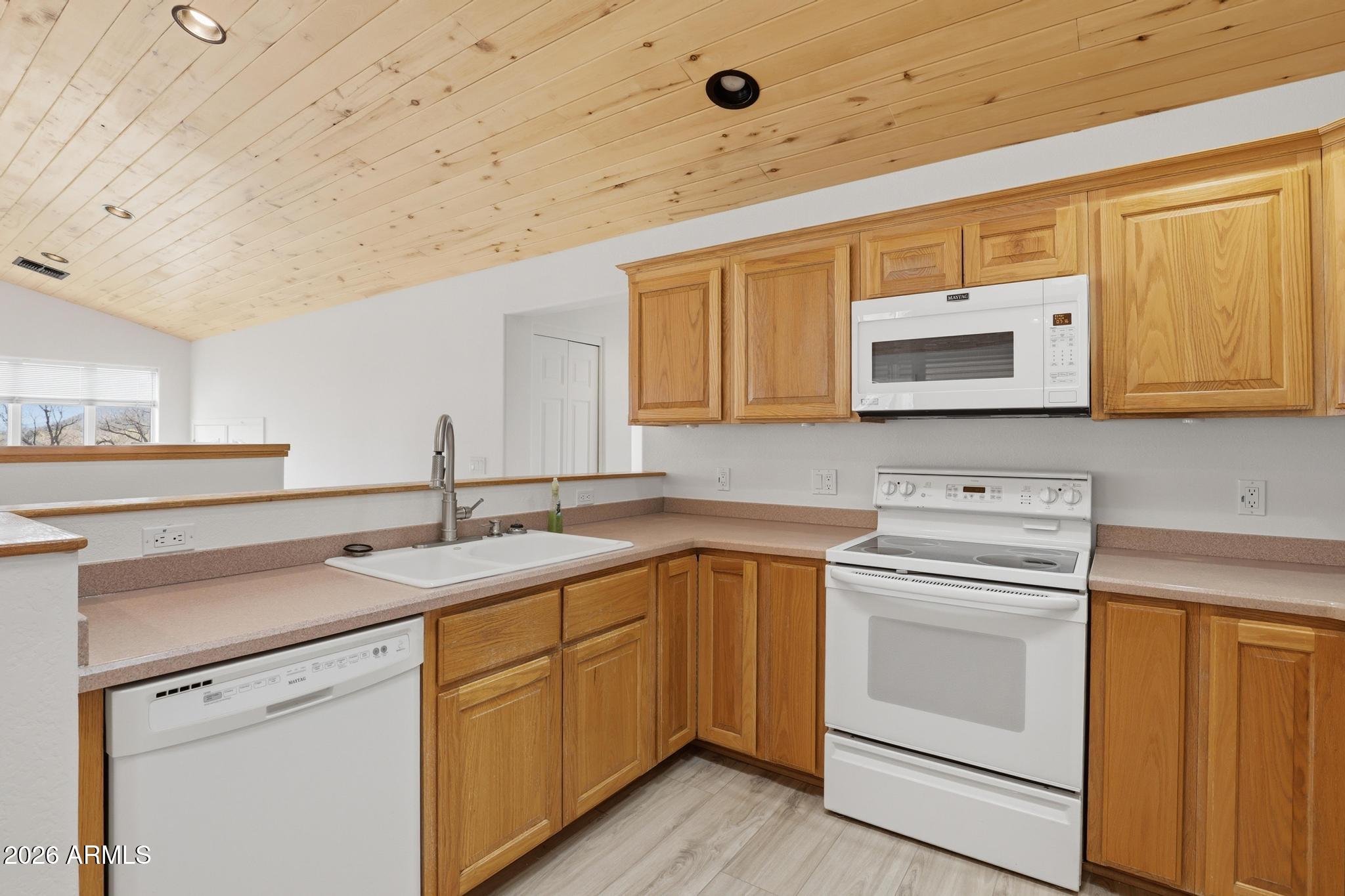 8780 Singletree Lane Payson, AZ 85541 - Photo 7 of 37 a kitchen with a sink stove and microwave