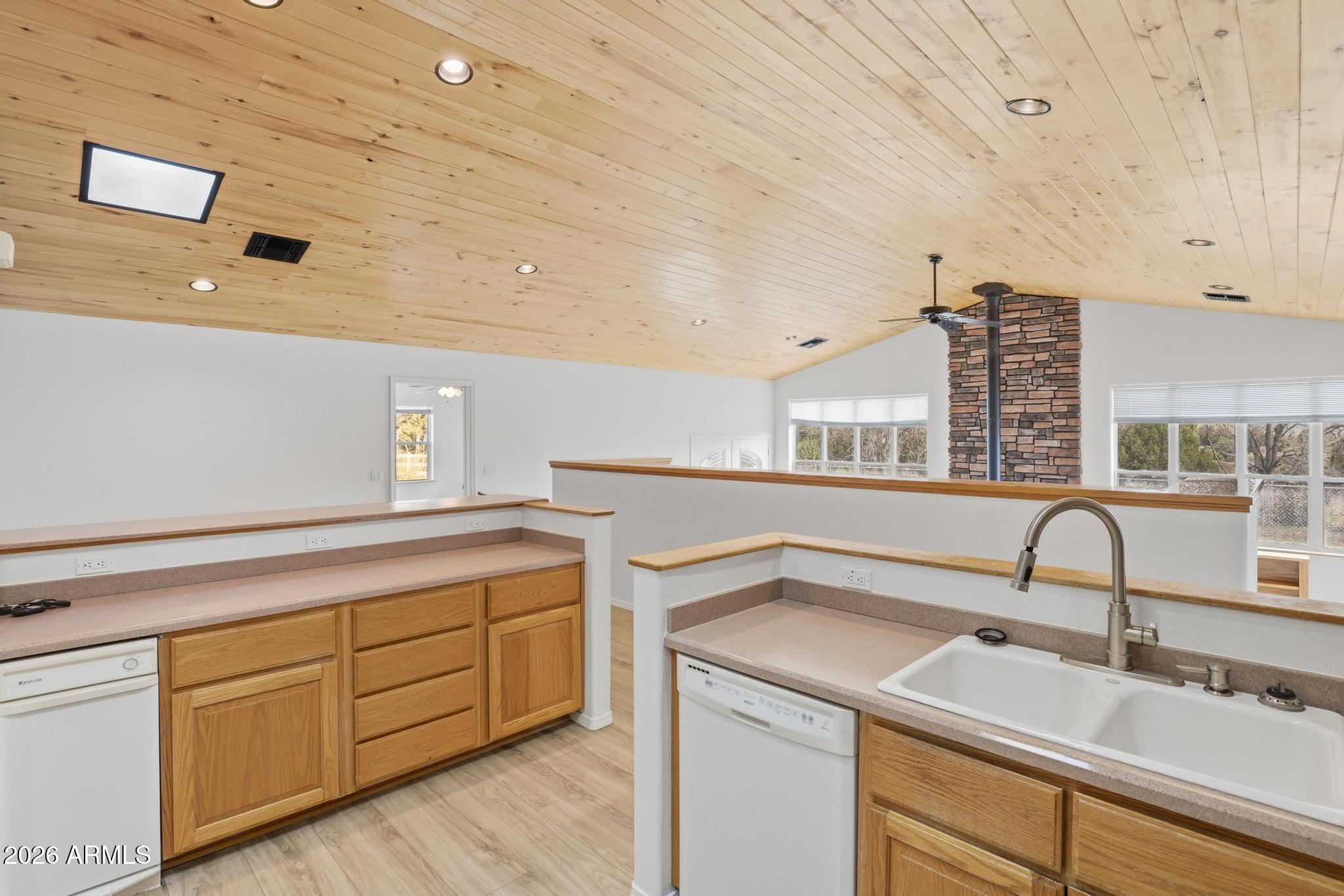 8780 Singletree Lane Payson, AZ 85541 - Photo 10 of 37 a kitchen with a sink cabinets and appliances