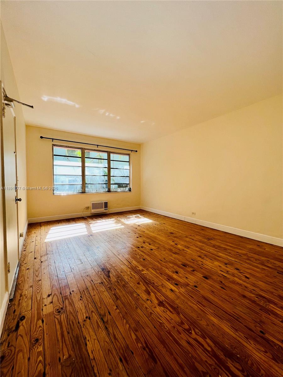 1141 Meridian Avenue, Unit 6 Miami Beach, FL 33139 - Photo 1 of 11 wooden floor in an empty room with a window
