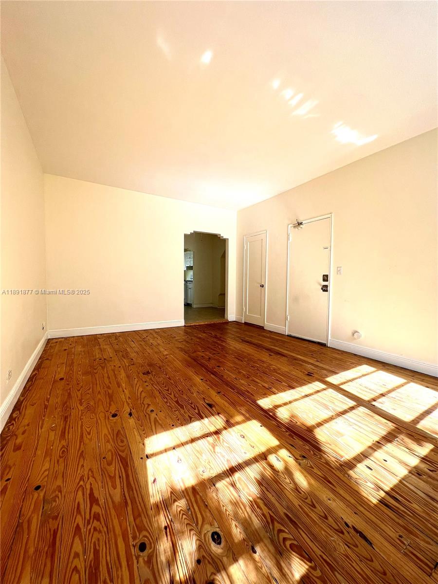 1141 Meridian Avenue, Unit 6 Miami Beach, FL 33139 - Photo 2 of 11 a view of a room with wooden floor and a window