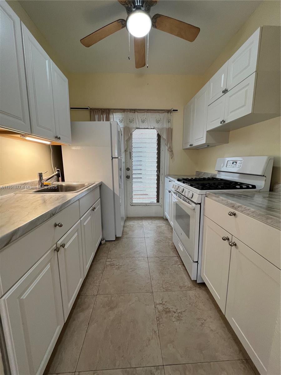 1141 Meridian Avenue, Unit 6 Miami Beach, FL 33139 - Photo 5 of 11 a kitchen with cabinets and window
