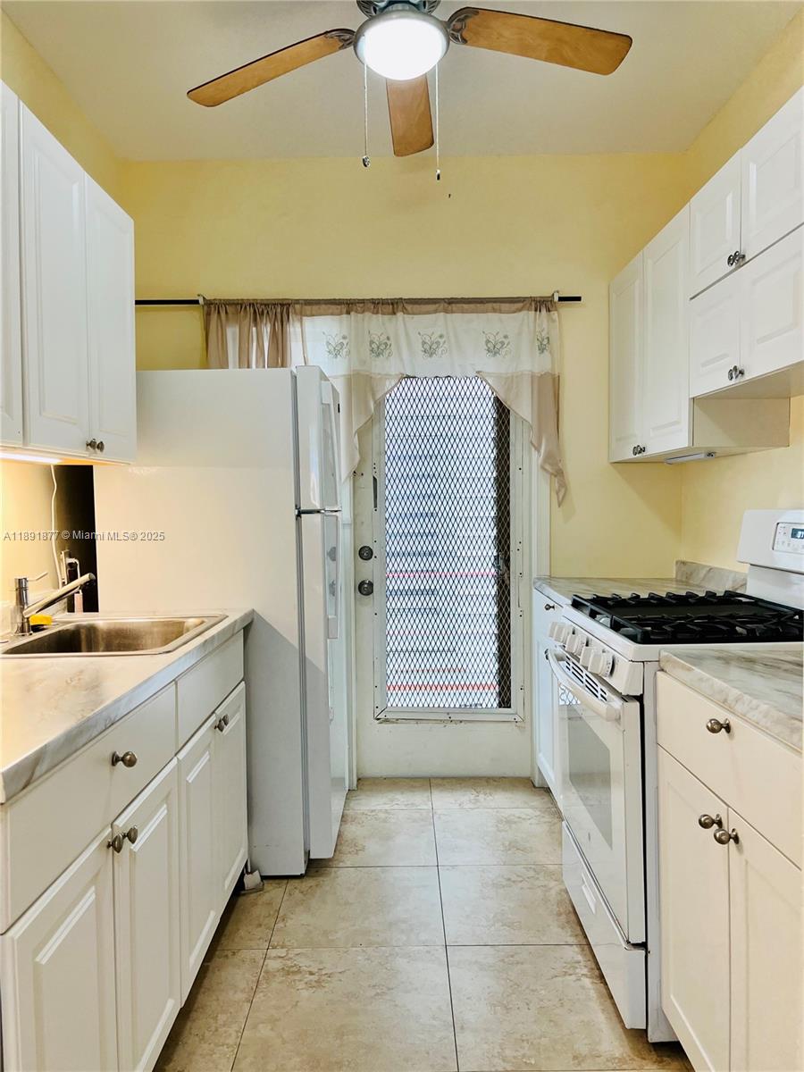 1141 Meridian Avenue, Unit 6 Miami Beach, FL 33139 - Photo 6 of 11 a kitchen with a sink and cabinets