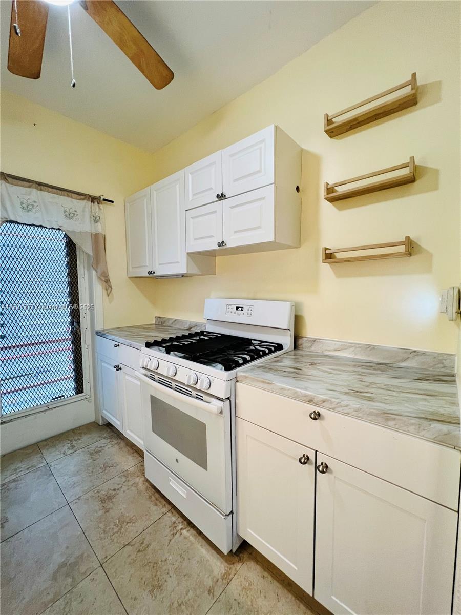 1141 Meridian Avenue, Unit 6 Miami Beach, FL 33139 - Photo 7 of 11 a kitchen with a stove cabinets and a sink