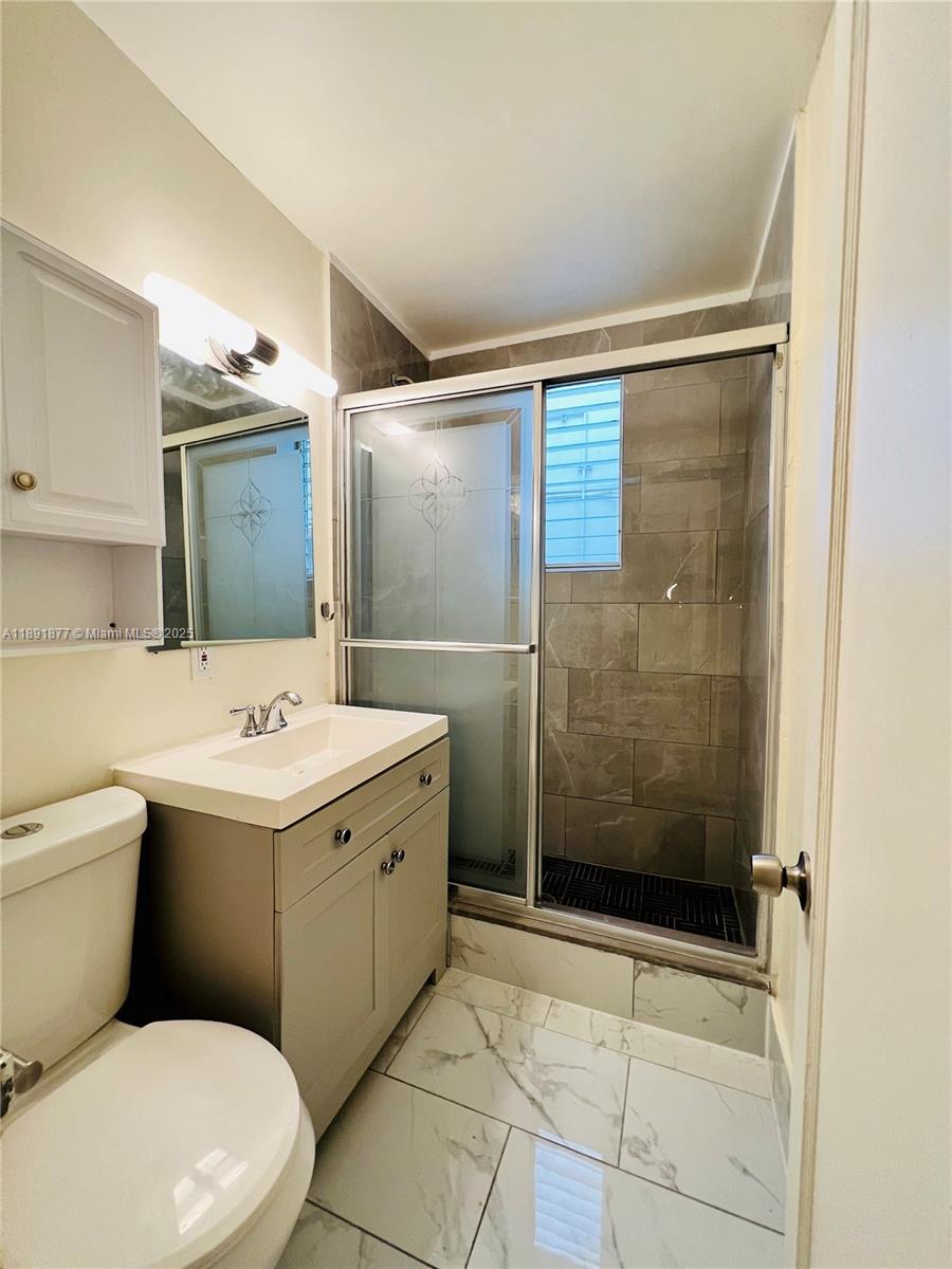 1141 Meridian Avenue, Unit 6 Miami Beach, FL 33139 - Photo 9 of 11 a bathroom with a sink toilet and shower