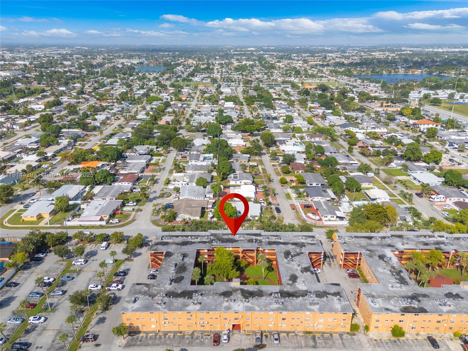 1330 West 54th Street, Unit 302C Hialeah, FL 33012 - Photo 18 of 20 an aerial view of residential houses with outdoor space and swimming pool