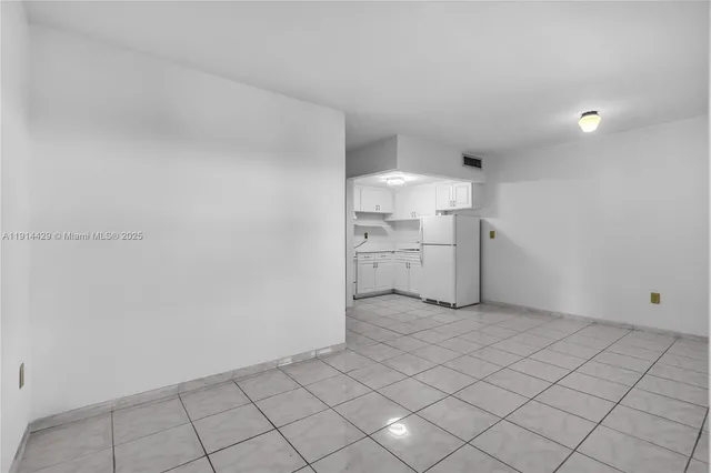 a view of a kitchen with white cabinets