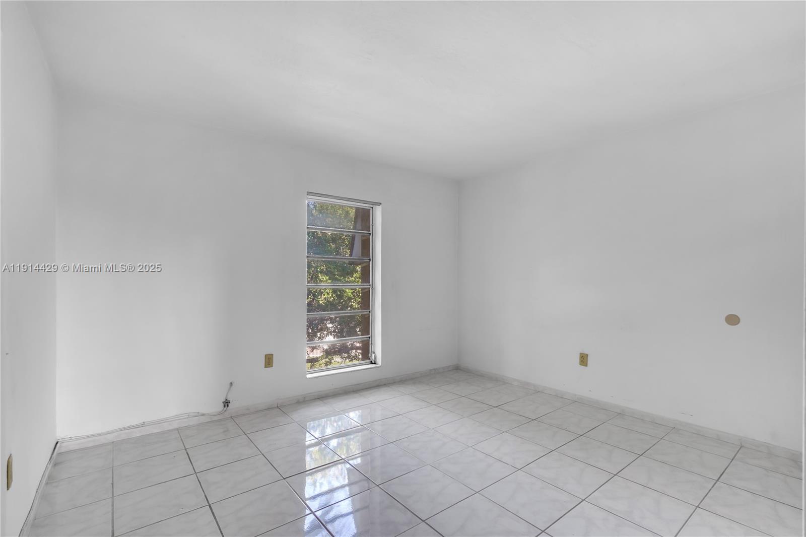 1330 West 54th Street, Unit 302C Hialeah, FL 33012 - Photo 10 of 20 a view of an empty room with a window