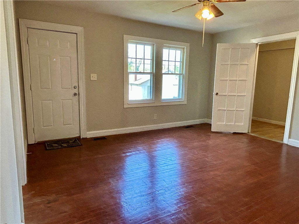 181 Sumter Street Anderson, SC 29621 - Photo 5 of 17 This inviting living space features warm wood floors and ample natural light, creating a bright and welcoming atmosphere.