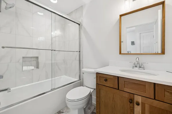 a bathroom with a sink a toilet and a mirror