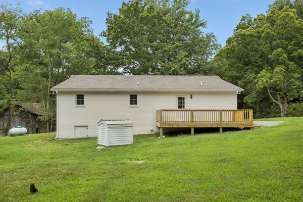 a view of a house with a backyard and a patio