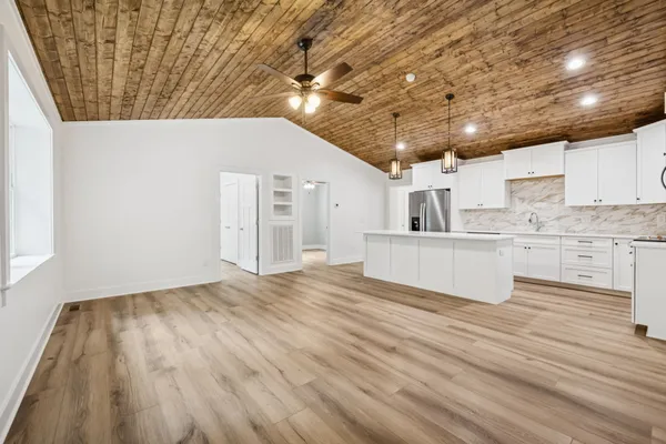 a view of kitchen with cabinets and wooden floor
