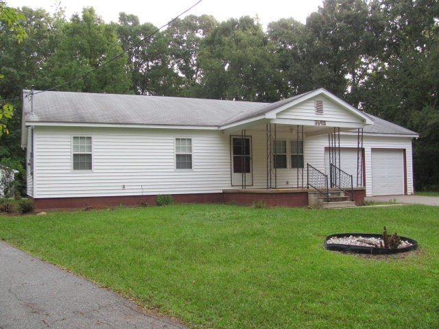 3598 Stokes Store Road, Unit 2 Forsyth, GA 31029 - Photo 1 of 1 a front view of a house with a garden
