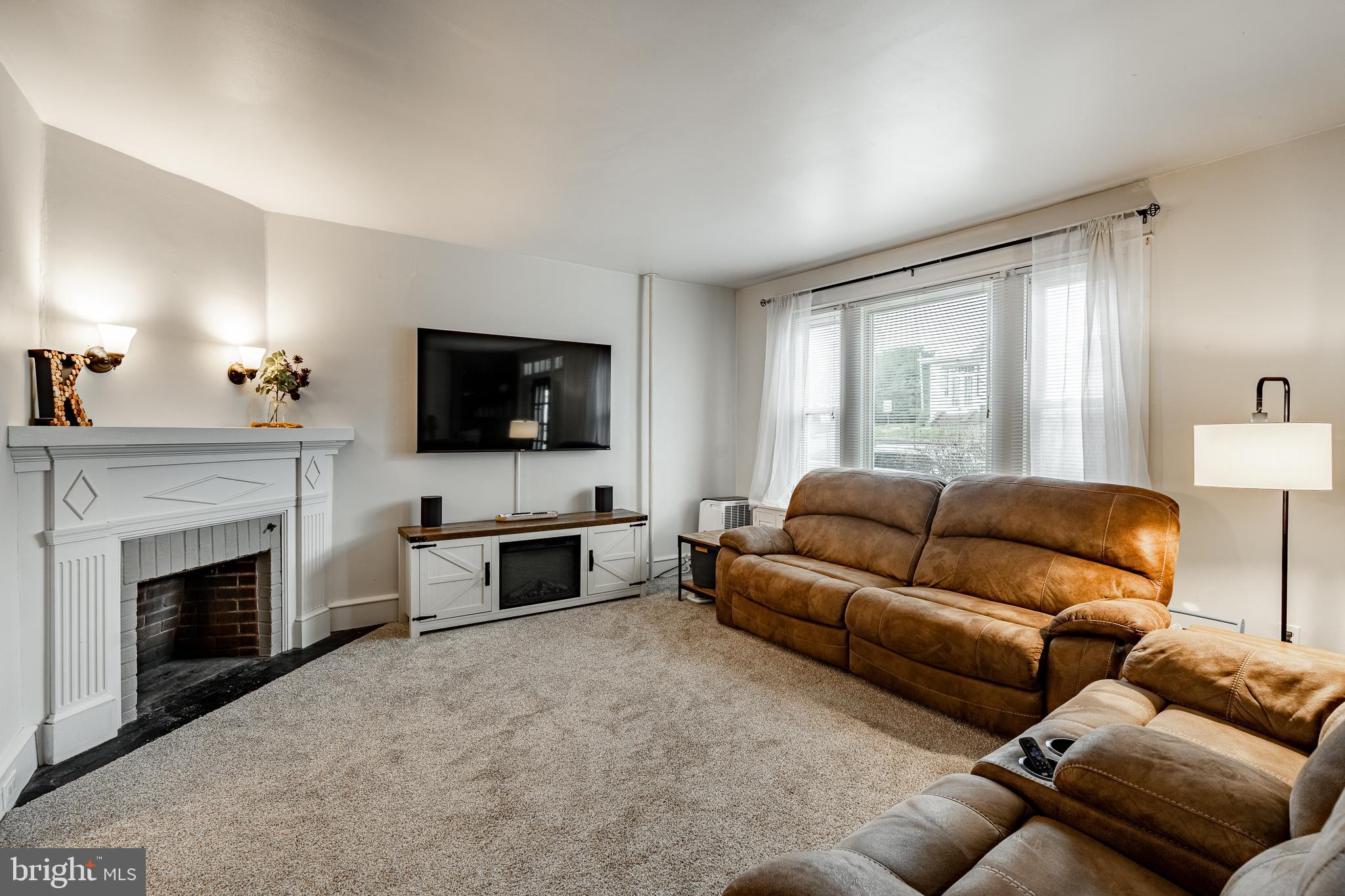 36 Fairview Street Boyertown, PA 19512 - Photo 12 of 40 a living room with furniture a flat screen tv and a fireplace