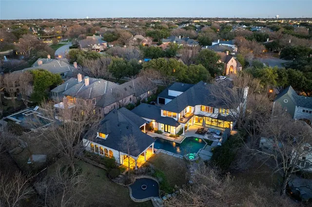 an aerial view of a house with a swimming pool yard and outdoor seating
