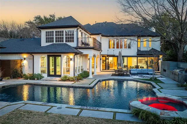a view of a house with pool and sitting area