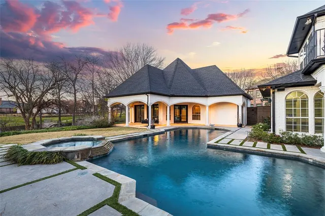 a front view of a house with swimming pool having outdoor seating