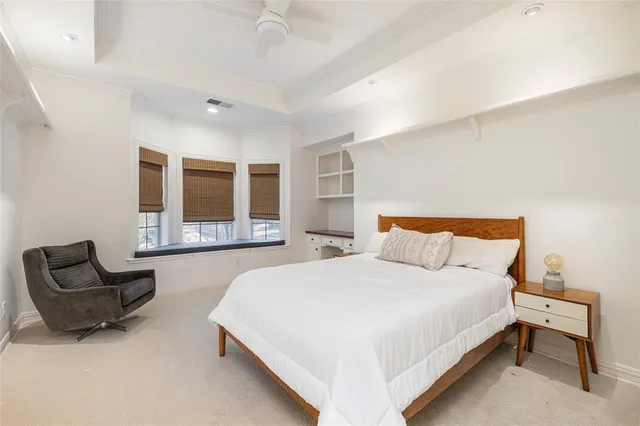 a spacious bedroom with a bed and window