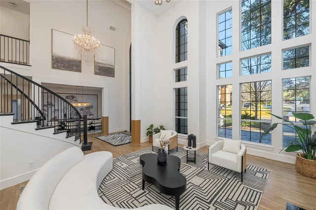 a living room with furniture and a floor to ceiling window