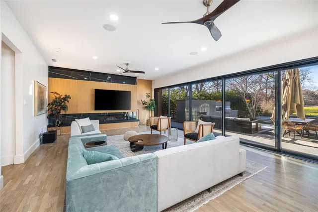a living room with furniture large windows and a flat screen tv
