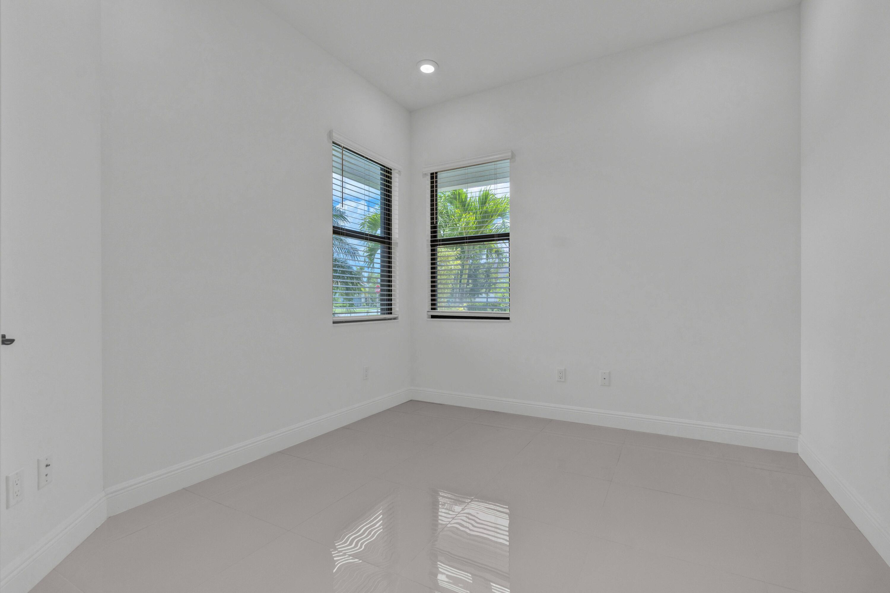 5501 Santa Rosa Lane Westlake, FL 33470 - Photo 12 of 31 an empty room with windows