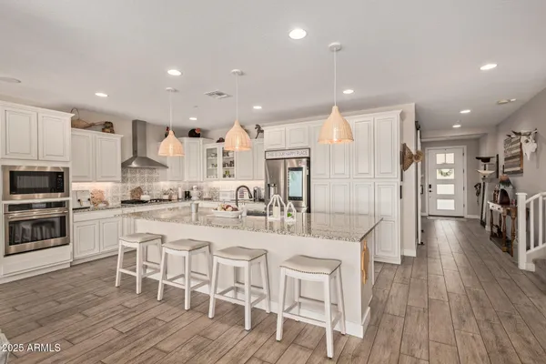 a large kitchen with a table and chairs