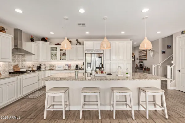 a kitchen with stainless steel appliances granite countertop a sink and cabinets
