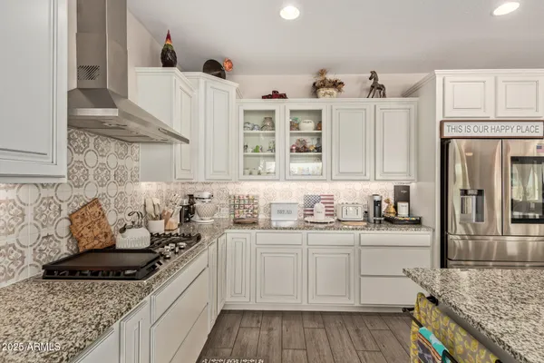 a kitchen with cabinets stainless steel appliances a sink and a stove