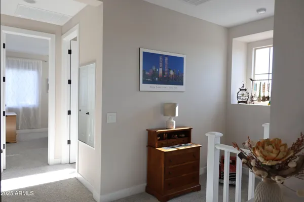 a bedroom with a bed table and window