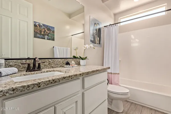 a view of a livingroom with workspace and a window