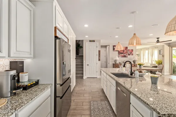 a large kitchen with a table and chairs in it