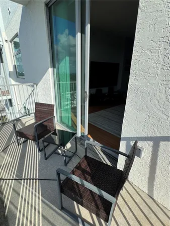 a view of a balcony with chairs