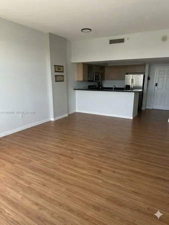 a view of a kitchen with a sink and cabinets