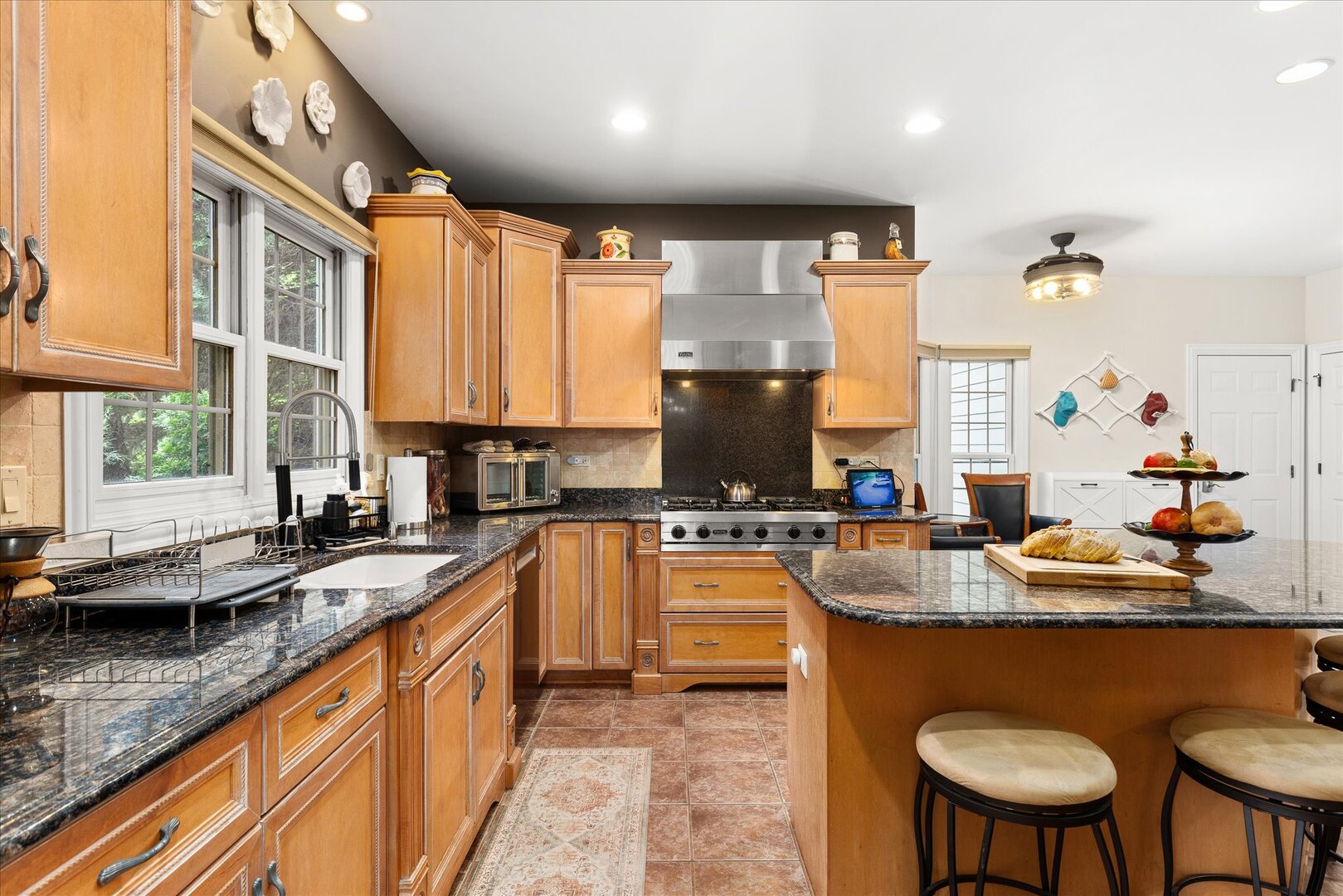 1330 Airport Road Morris, IL 60450 - Photo 8 of 53 a kitchen with stainless steel appliances granite countertop a sink a stove and a wooden cabinets