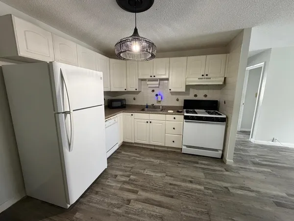 a kitchen with stainless steel appliances a refrigerator sink and cabinets