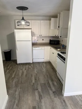 a kitchen with a refrigerator a stove a microwave and cabinets