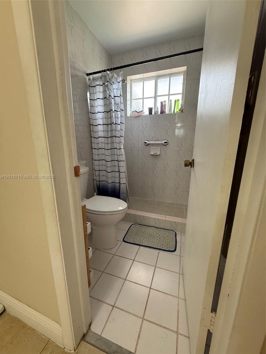 6720 Southwest 21st Street, Unit 1 Miami, FL 33155 - Photo 20 of 26 a bathroom with a toilet and a shower