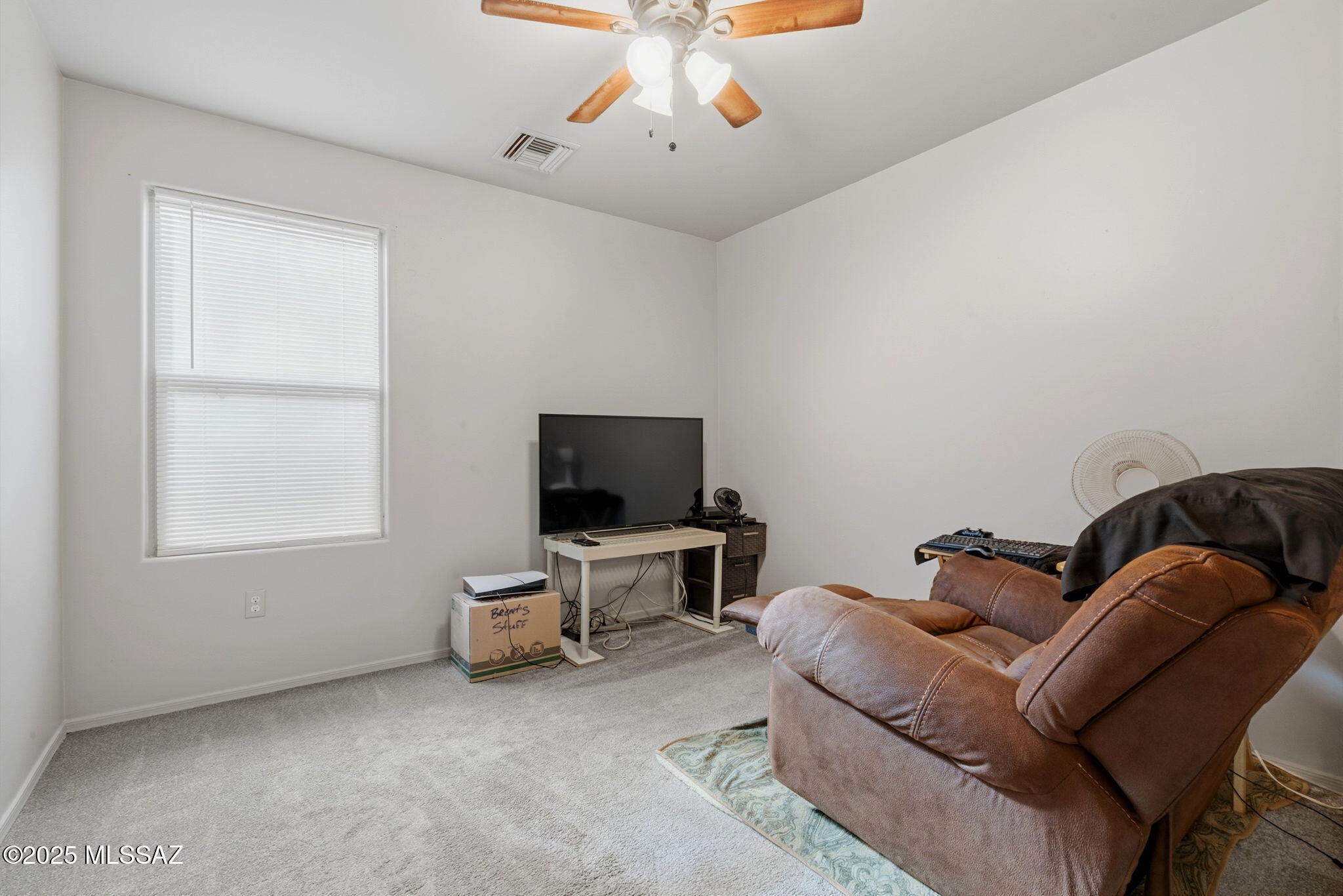 1458 North Wentworth Road Vail, AZ 85641 - Photo 13 of 44 a living room with furniture and a flat screen tv