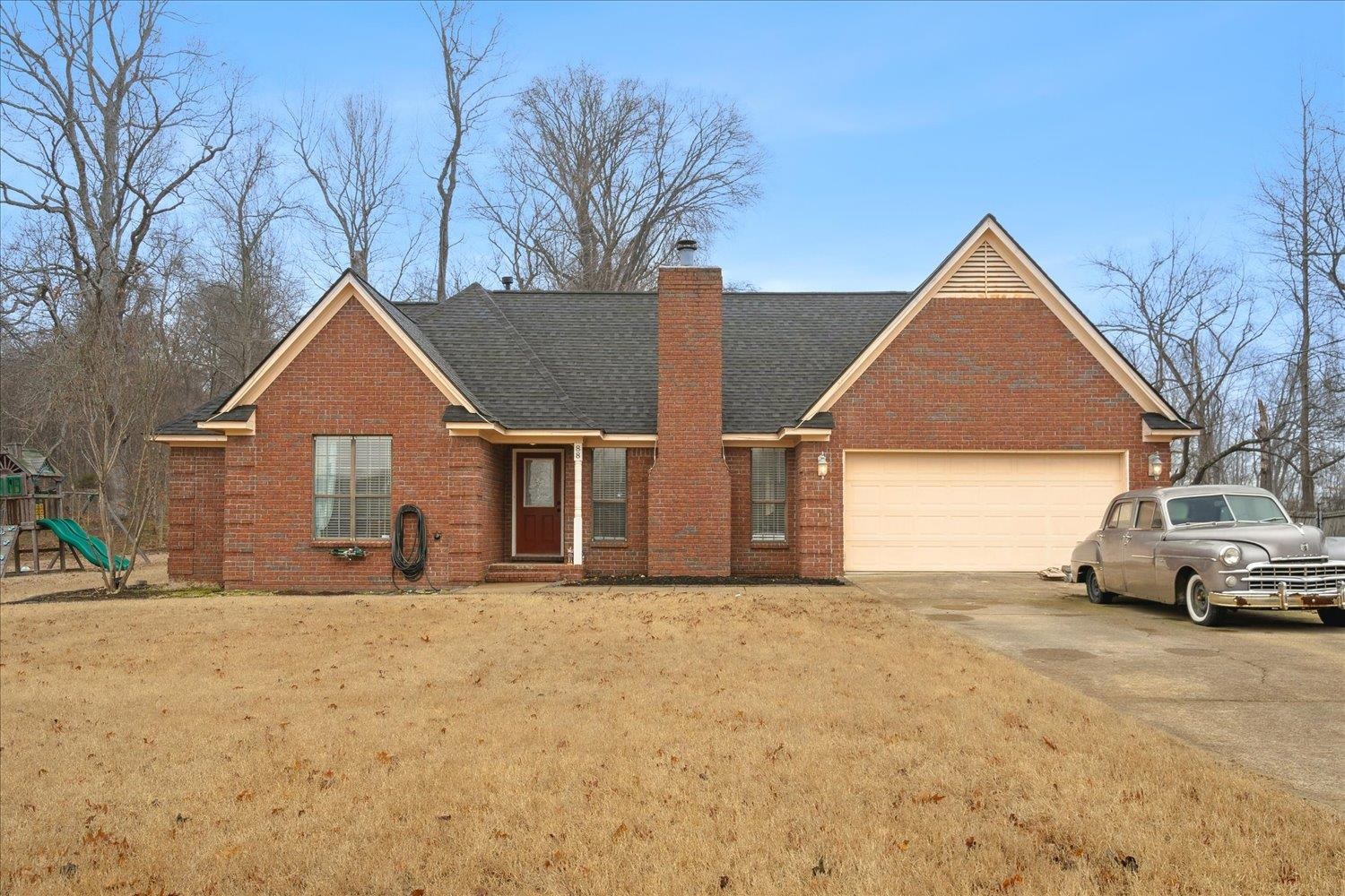 88 East Rae Road Munford, TN 38058 - Photo 30 of 30 View of front facade with a garage, a playground, and a front yard
