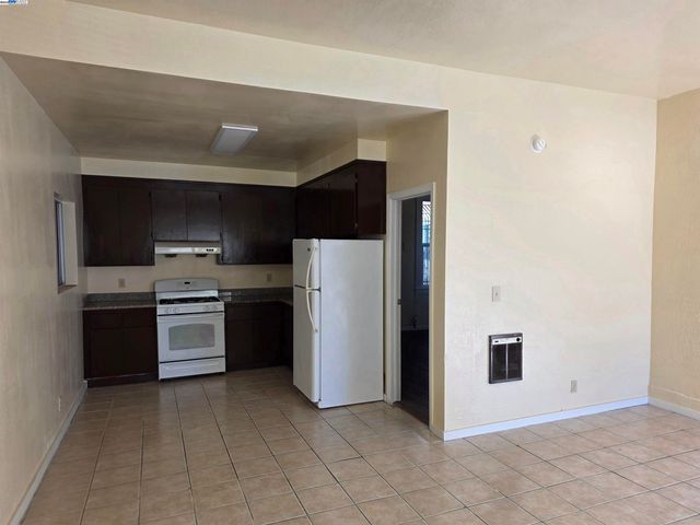 a kitchen with a refrigerator sink and stove top oven