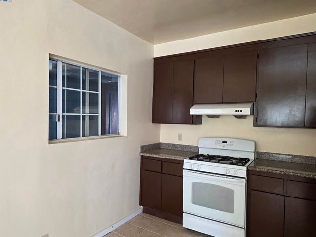 a kitchen with a stove cabinets and a refrigerator