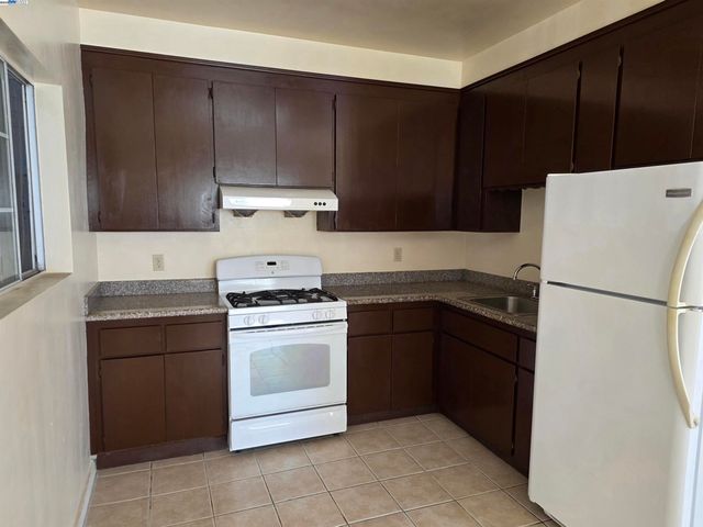 a kitchen with a cabinets stove and refrigerator