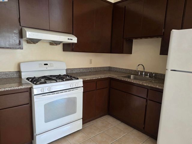 a kitchen with a stove and a sink