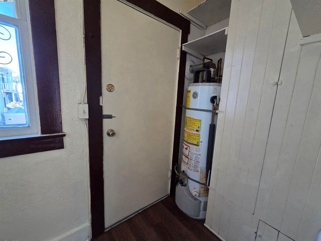 a room with wooden floor and windows