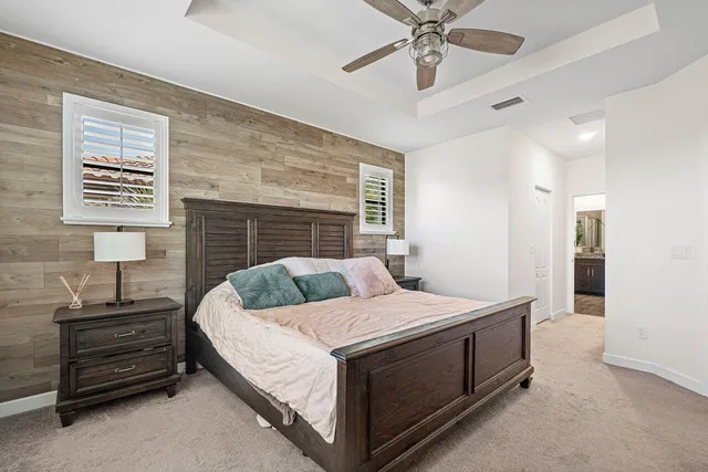 a bedroom with a bed and ceiling fan