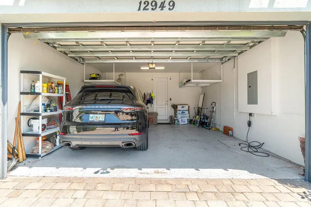 a picture of a room with stairs and a chandelier