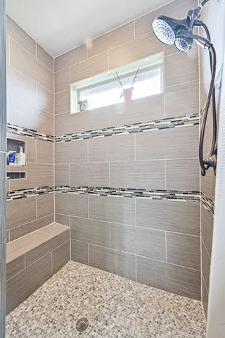 a bathroom with a glass shower door